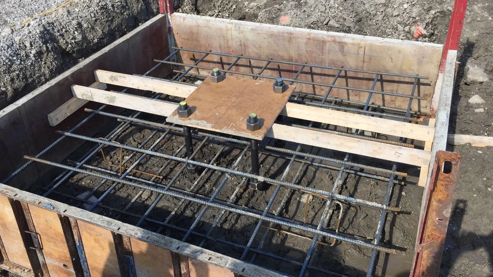 Concrete footing formwork with reinforcement and anchor bolts